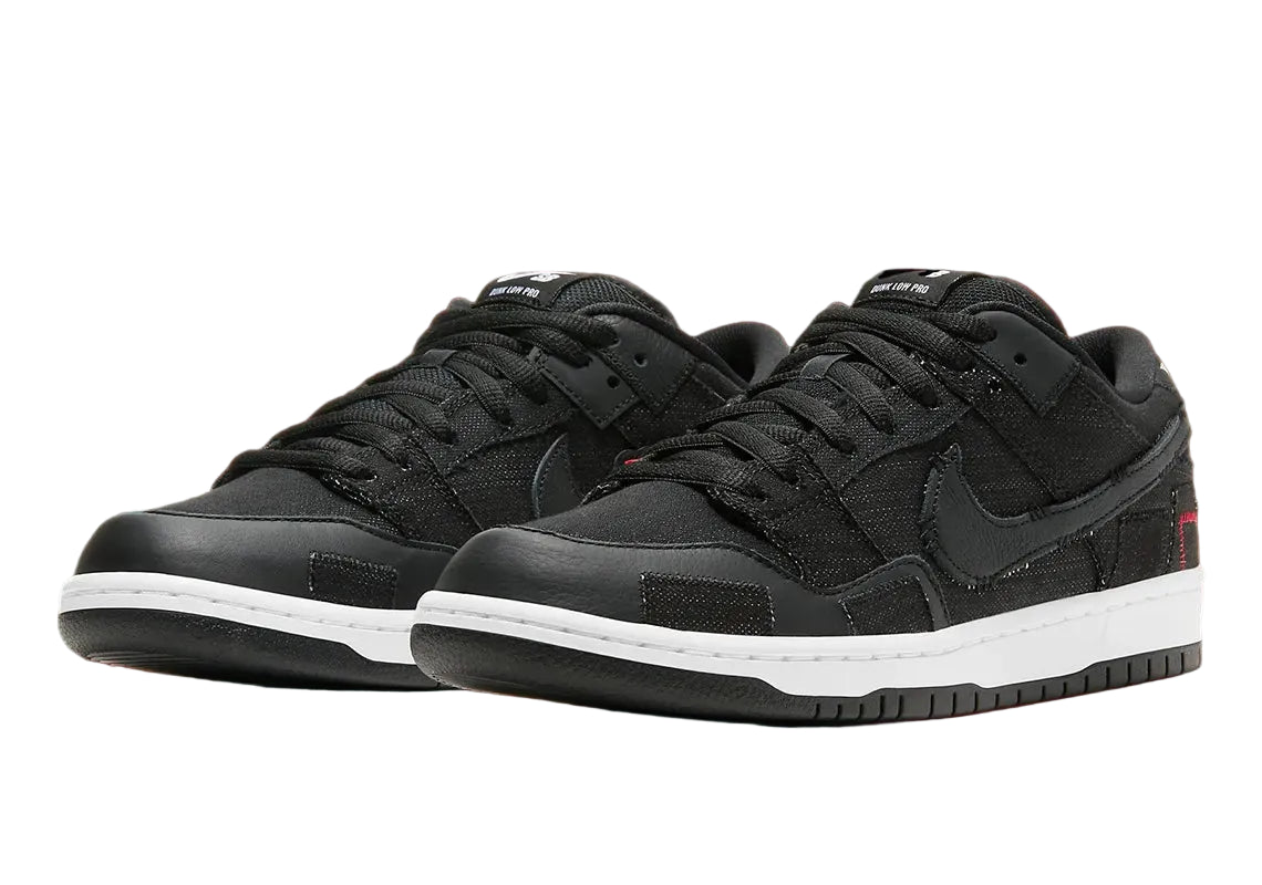 Black sneakers with white soles on a red background